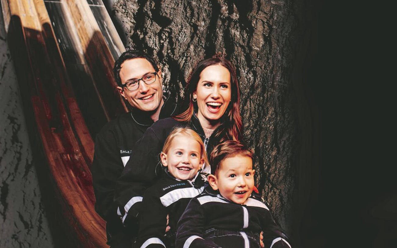 Family enjoying slide at Berchtesgaden Salt Mines, Salzburg tour.