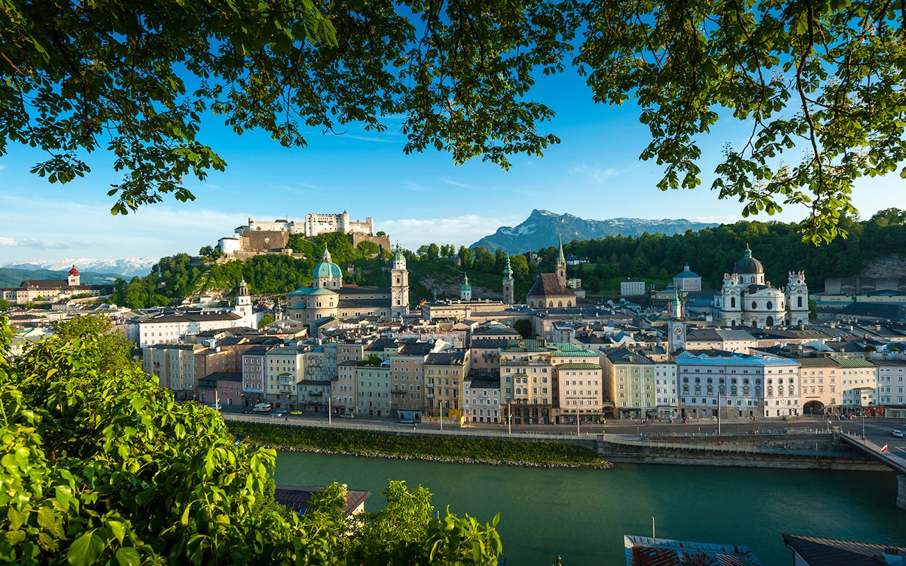 Salzburg cityscape with Hohensalzburg Fortress and Salzach River on hop-on hop-off tour.