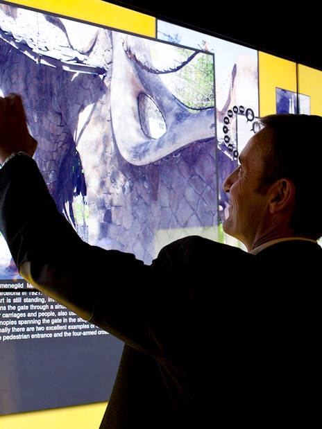 Man interacting with digital display at Gaudí 4D Experience in Barcelona.