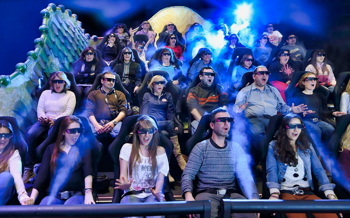 Visitors experiencing Gaudí 4D Experience with 3D glasses and special effects.