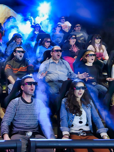 Visitors experiencing Gaudí 4D Experience with 3D glasses and special effects.