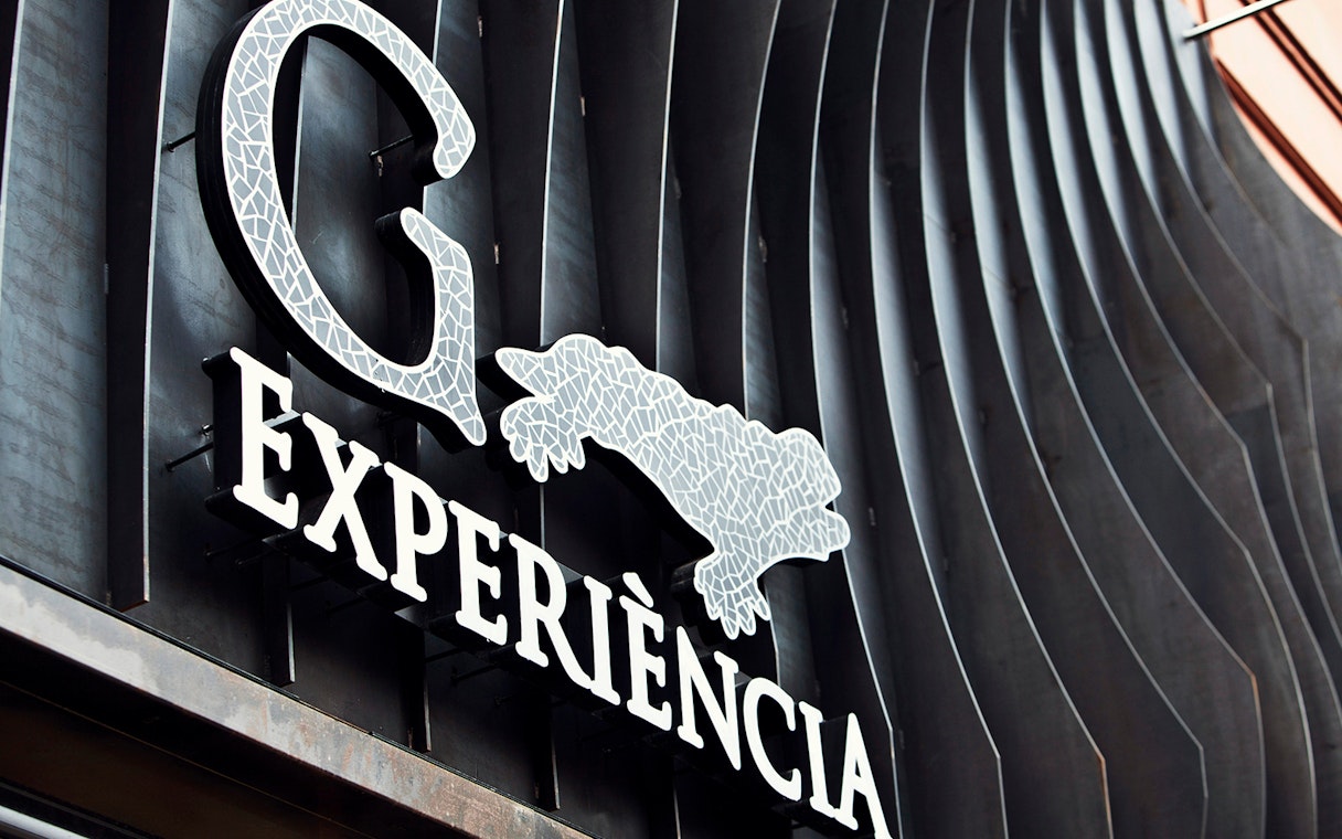 Gaudí 4D Experience sign with mosaic design in Barcelona.