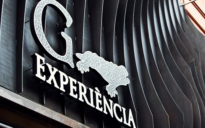 Gaudí 4D Experience sign with mosaic design in Barcelona.