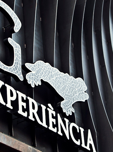 Gaudí 4D Experience sign with mosaic design in Barcelona.