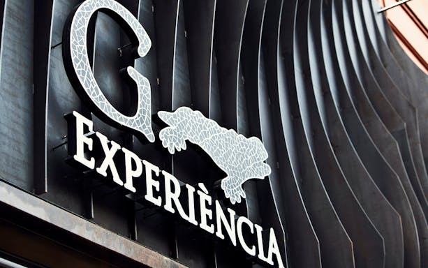 Gaudí 4D Experience sign with mosaic design in Barcelona.