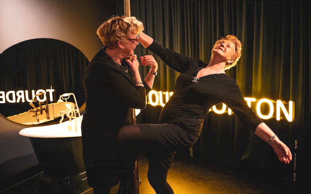 Visitors engaging in a pole dance activity at Tour de BonTon.