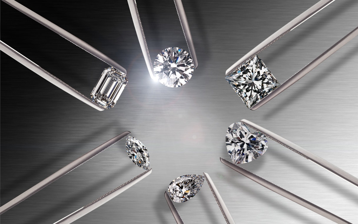 Various diamond cuts displayed with tweezers at Diamond Museum Amsterdam.