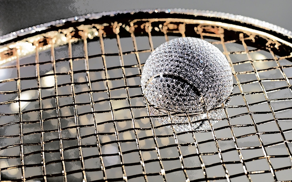 Diamond-encrusted tennis ball on a racket at Diamond Museum Amsterdam.