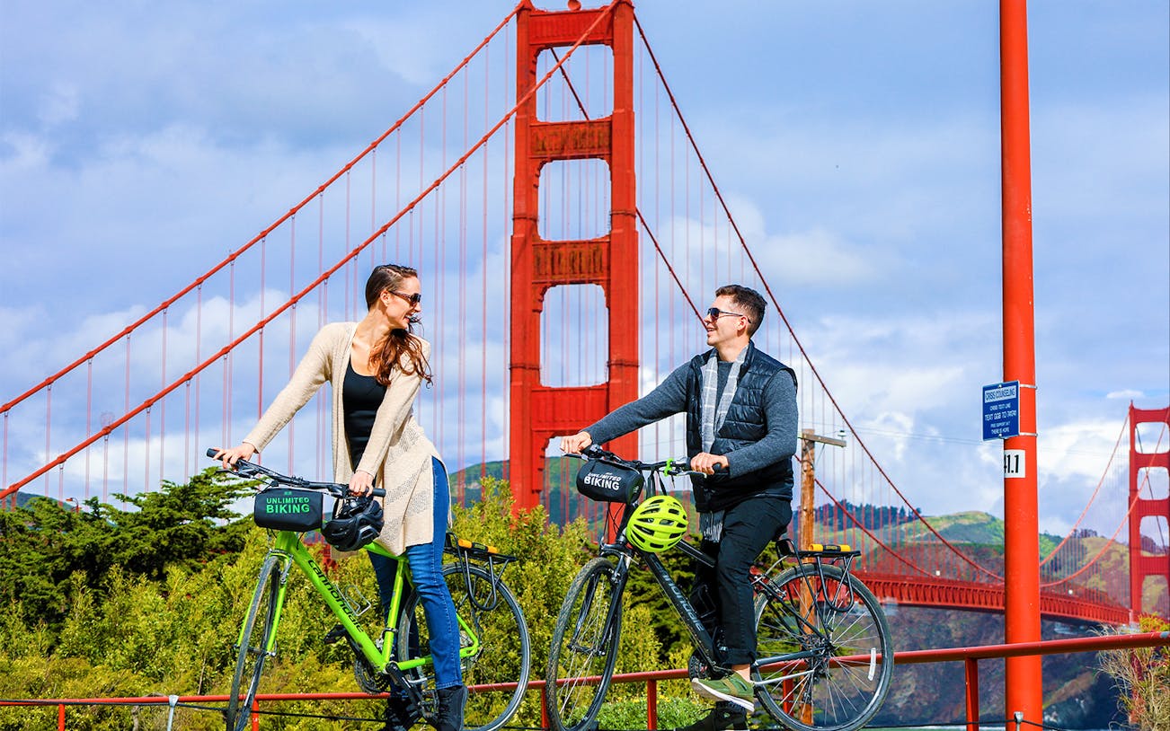 Couple biking near Golden Gate Bridge, San Francisco.