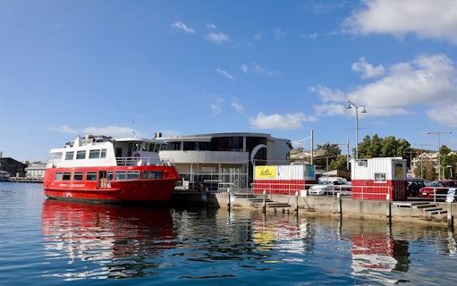Red ferry docked at Hobart waterfront for historic lunch cruise.