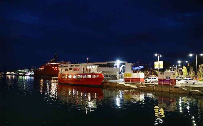Red ferry docked at night for Hobart Historic Dinner Cruise, Tasmania.