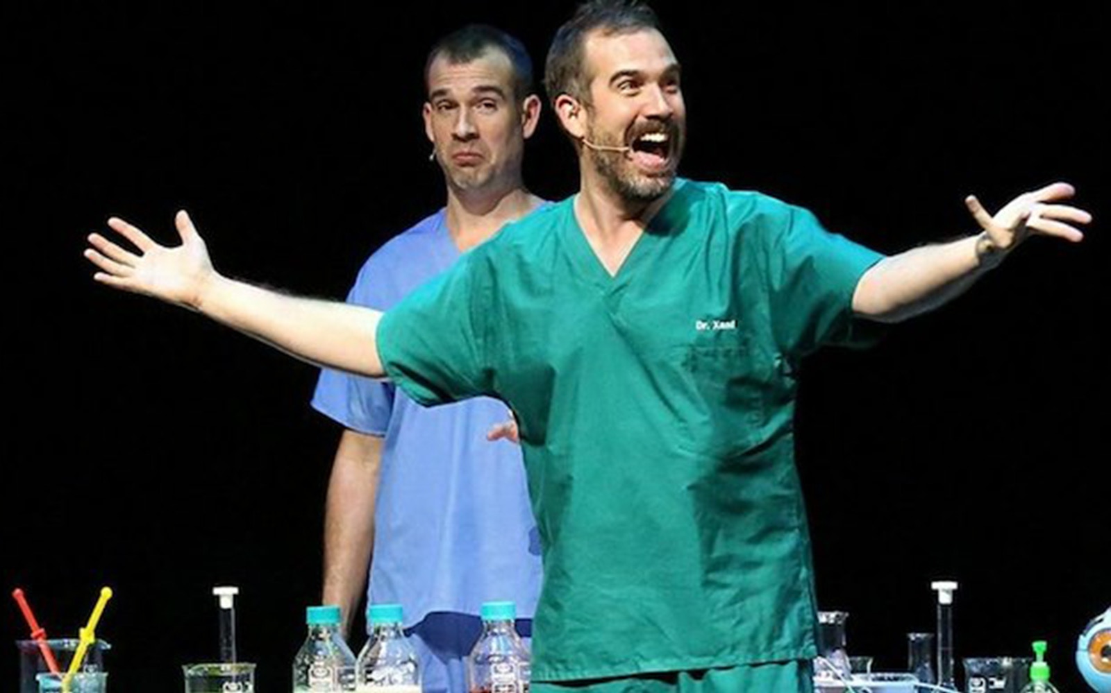 Performers in medical scrubs on stage during Operation Ouch Live show.