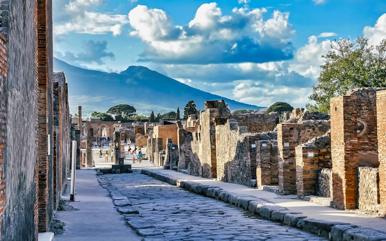 Ancient street in Pompeii with Mount Vesuvius in the background.