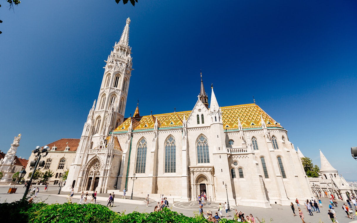 Matthias Church in Budapest with colorful roof and tall spire, seen on a day trip from Vienna.