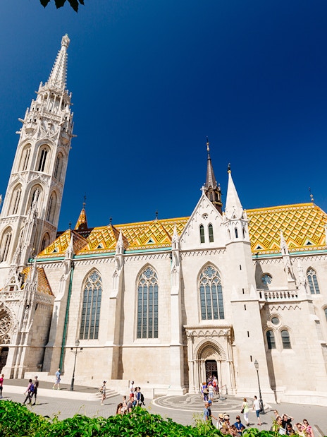 Matthias Church in Budapest with colorful roof and tall spire, seen on a day trip from Vienna.