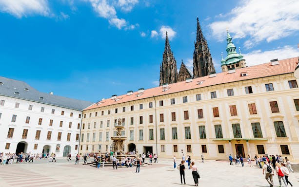 Prague Castle courtyard with tourists, view from Vienna day trip.