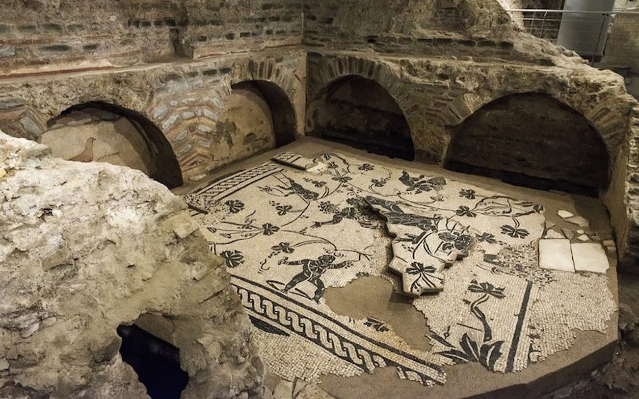 Ancient Roman mosaic floor in the underground catacombs, part of the Roman Catacombs Tour.