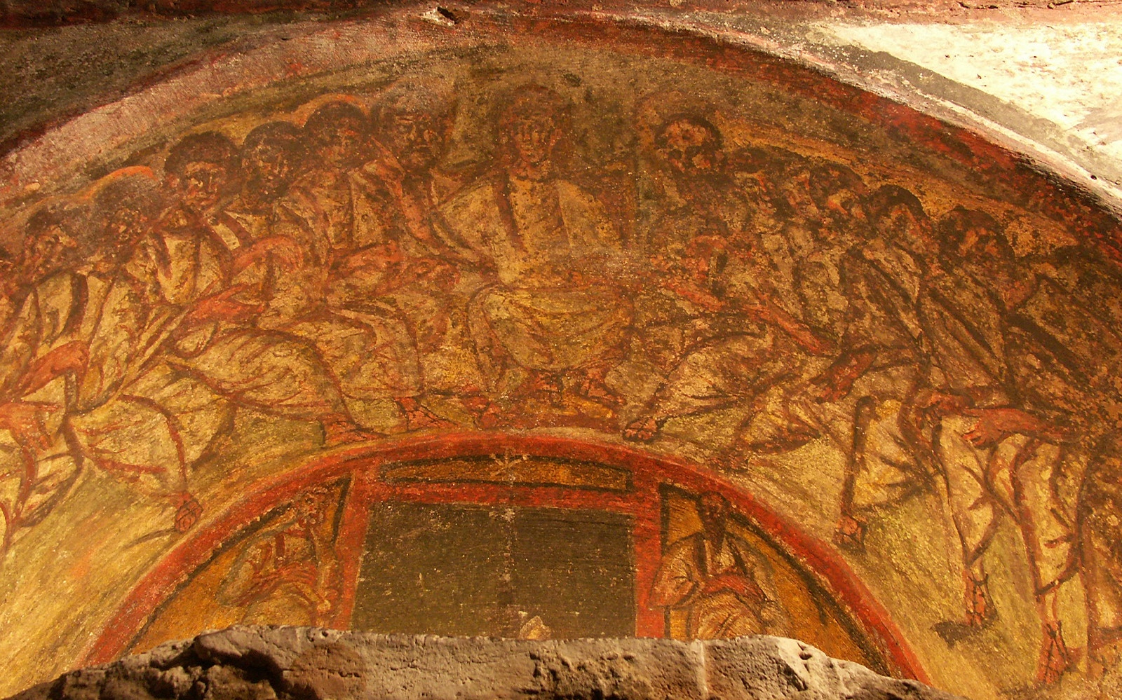 Ancient fresco in the Roman Catacombs depicting a religious scene, part of the Underground Roman Catacombs Tour.
