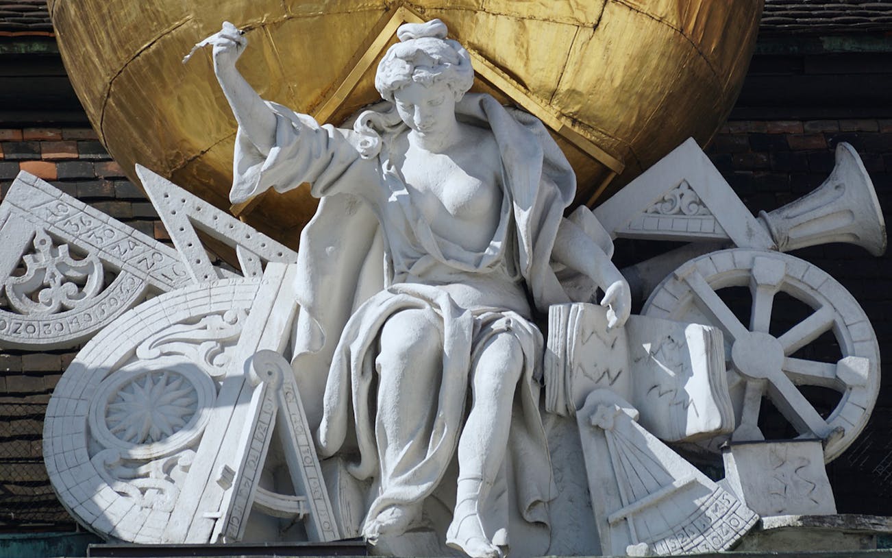Statue of a seated figure with scientific instruments, Vienna, Austria.