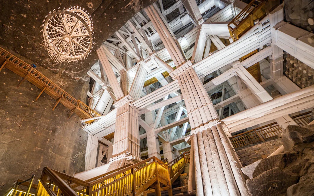 Salt mine chamber with wooden beams and chandelier, Wieliczka, Poland.