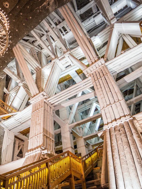 Salt mine chamber with wooden beams and chandelier, Wieliczka, Poland.