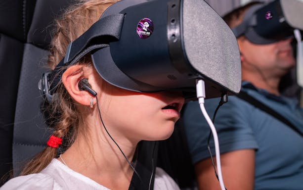Child wearing VR headset on Future Bus Tour in Vienna.