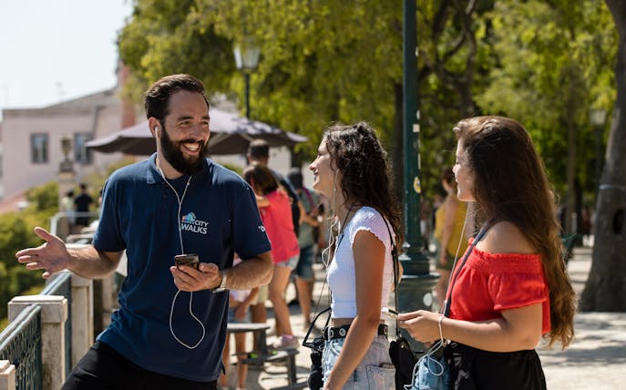 Guide leading a Lisbon walking tour with participants listening and engaging.