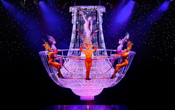 Performers on a chandelier at Lido de Paris Cabaret Show.