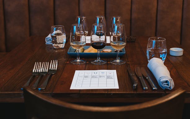 Wine glasses and food pairings on a table at City Winery experience.