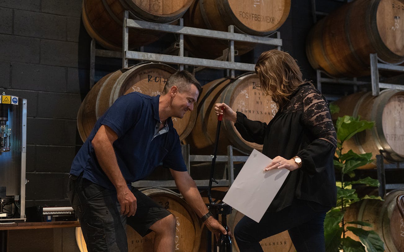 Wine blending workshop at City Winery with participants using a wine press.