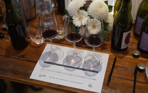 Wine glasses and bottles on a table at City Winery Wine Blending Workshop.