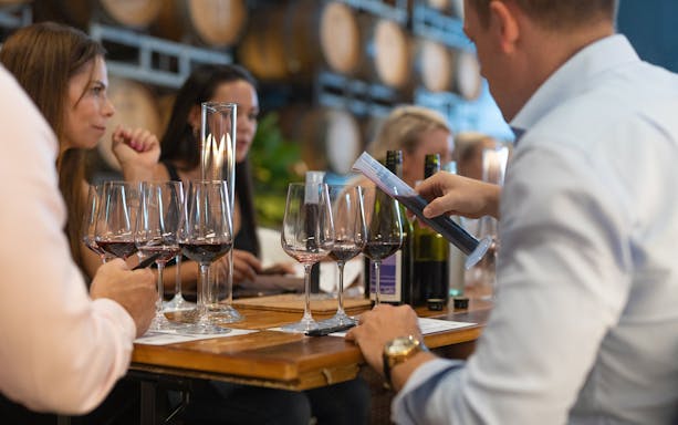 Participants blending wine at City Winery workshop with glasses and measuring tools.