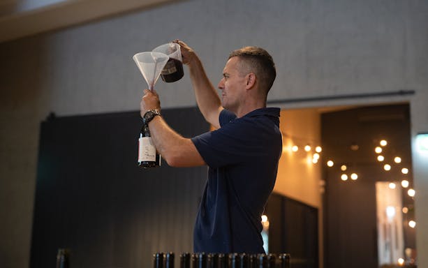 Man blending wine at City Winery workshop.