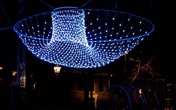 Blue light installation at Amsterdam Light Festival during a luxury canal cruise.