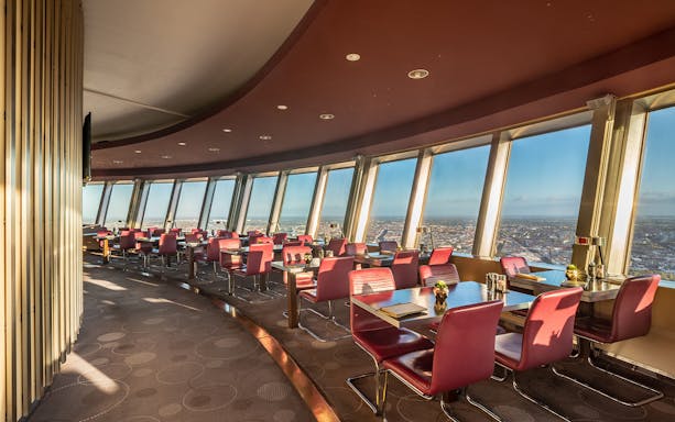 Berlin TV Tower restaurant with panoramic city views and red seating.