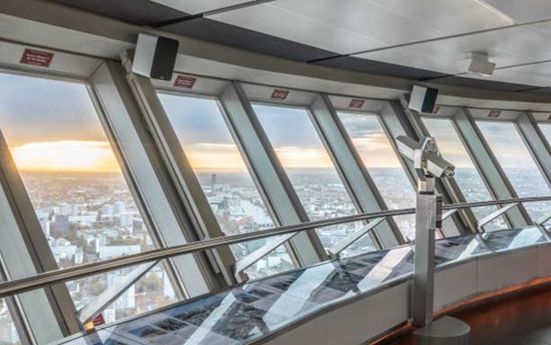 Berlin TV Tower observation deck with city view and telescope.