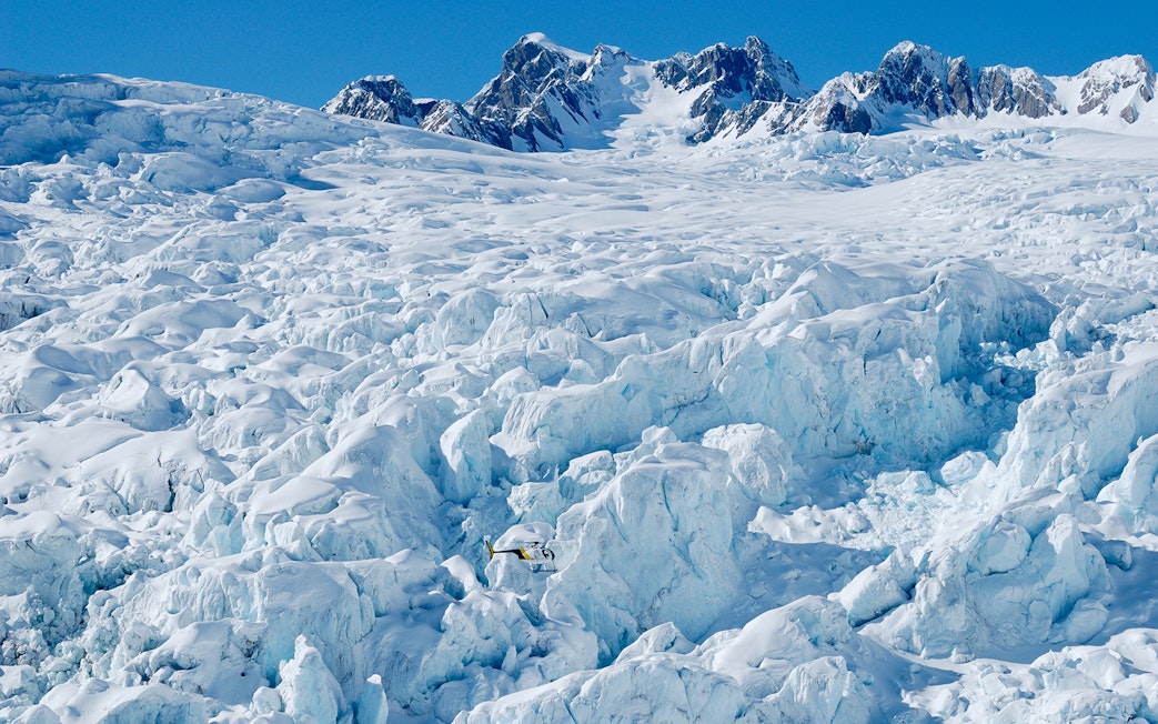 Helicopter flying over Fox and Franz Josef Glaciers in New Zealand.