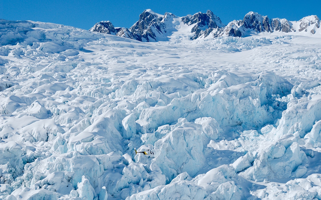 Helicopter flying over Fox and Franz Josef Glaciers in New Zealand.