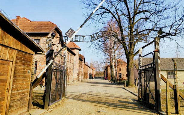 Entrance gate to Auschwitz concentration camp with "Arbeit Macht Frei" sign, Poland.