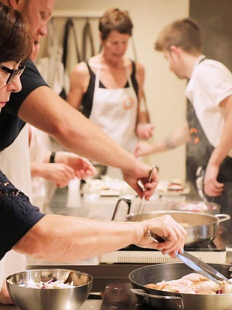 Small group cooking class in Florence preparing dinner together.