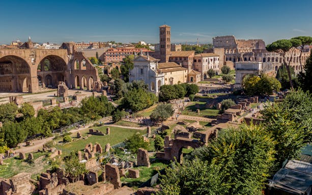 Ancient Roman Forum with Colosseum in background, Rome, Italy.