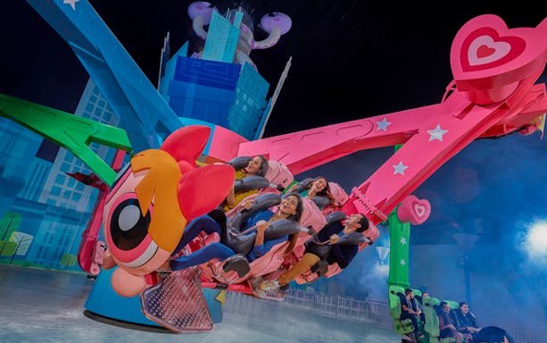Visitors enjoying a colorful ride at IMG Worlds of Adventure in Dubai.