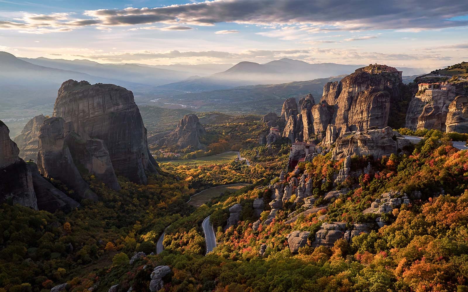 Meteora rock formations at sunset with autumn foliage, Greece.