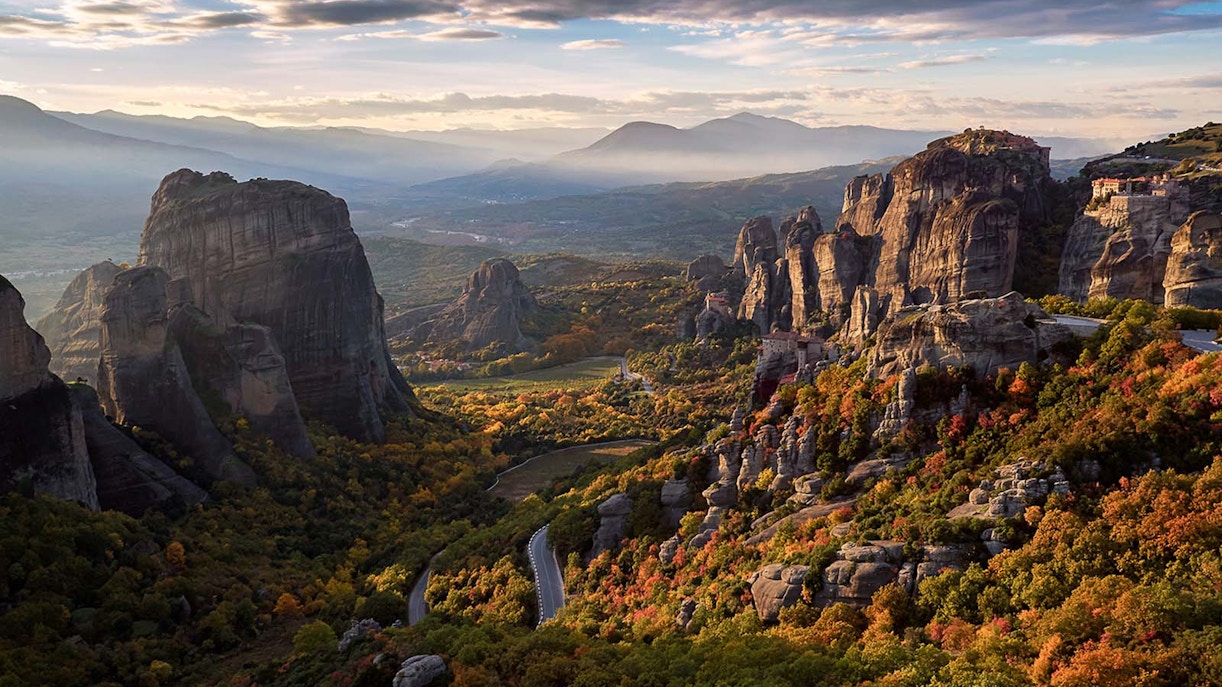 Meteora rock formations at sunset with autumn foliage, Greece.