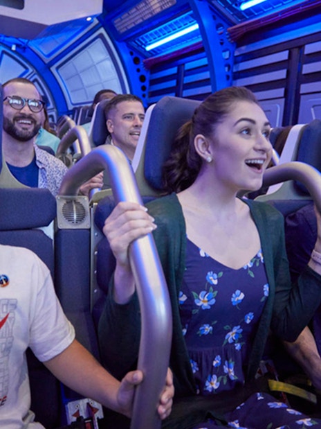 Visitors experiencing simulated shuttle cabin at Kennedy Space Center.
