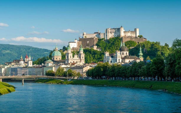 Salzburg cityscape with Hohensalzburg Fortress and Salzach River, view from Hop On Hop Off City Tour.