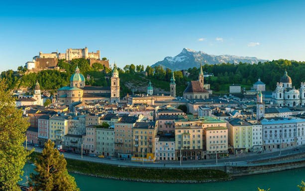 Salzburg cityscape with Hohensalzburg Fortress and Alps, view from Hop On Hop Off Yellow Line.