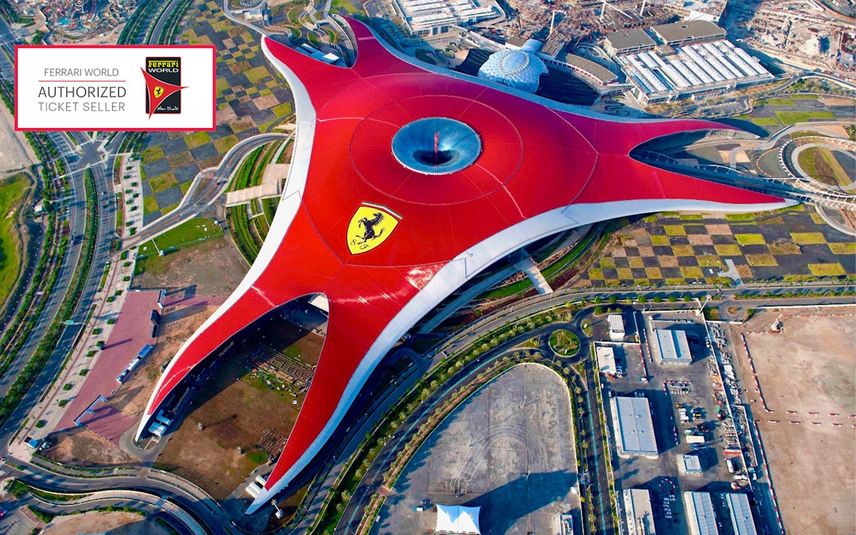 Aerial view of Ferrari World Abu Dhabi with its iconic red roof and Ferrari logo.