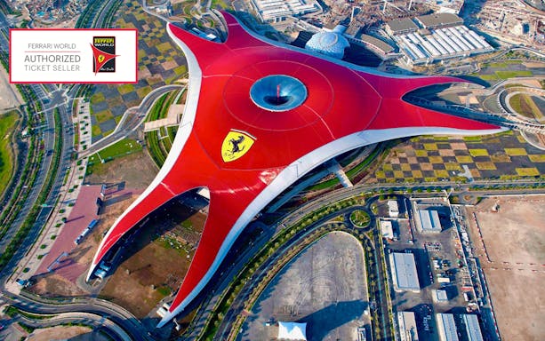 Aerial view of Ferrari World Abu Dhabi with its iconic red roof and Ferrari logo.