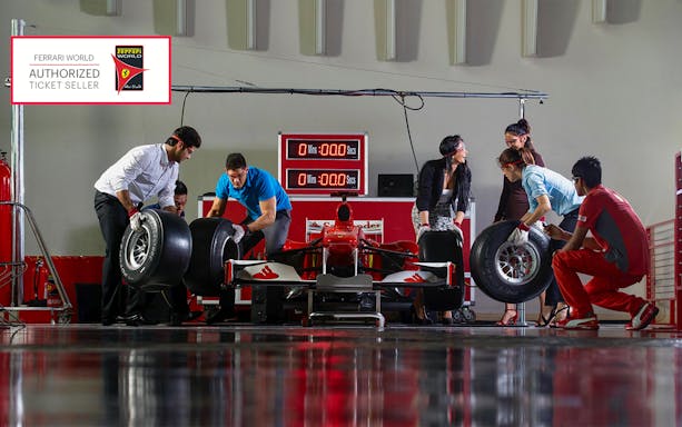 Team changing tires on a Formula 1 car at Ferrari World Abu Dhabi.